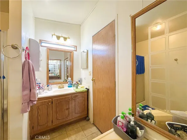 a bathroom with a sink mirror and tub