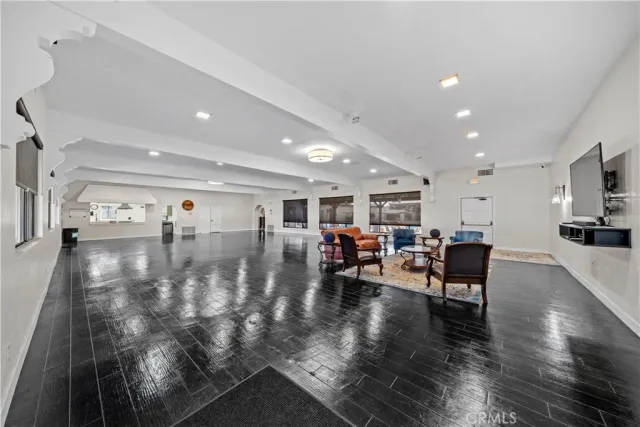 a living room with furniture and view of kitchen