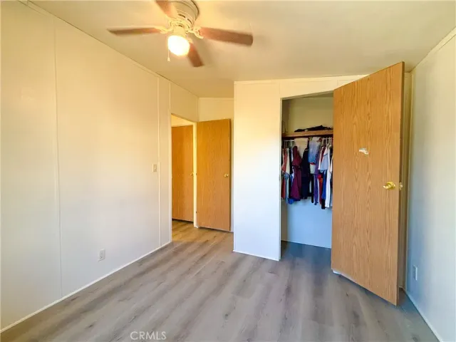 a view of a room with a hallway and wooden floor
