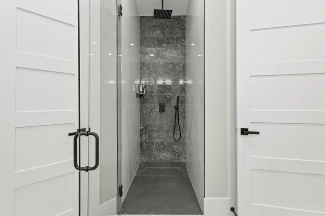 a bathroom with a double vanity sink mirror and bathtub