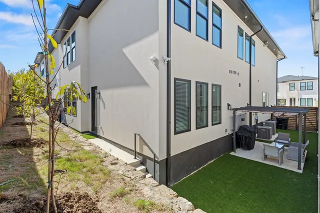 a view of backyard with seating area