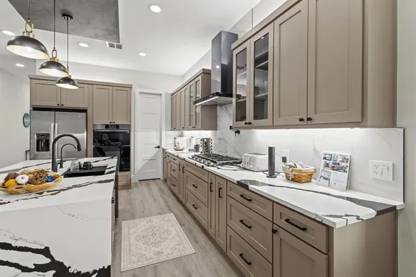 a kitchen with sink stove and cabinets