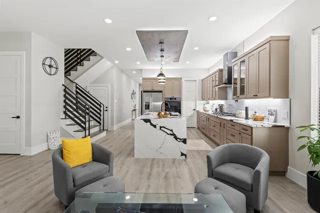 a living room with furniture a flat screen tv and a fireplace