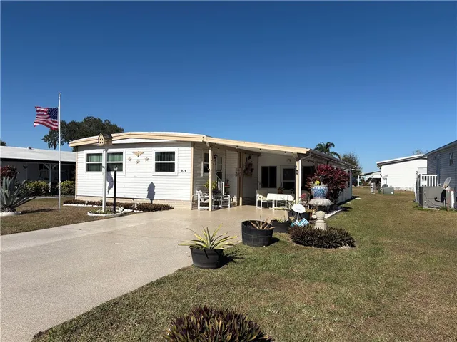 a view of a house with backyard and sitting area