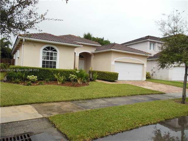 Keys Gate Homestead, FL 33035 - Photo 6 of 11 a front view of a house with a garden