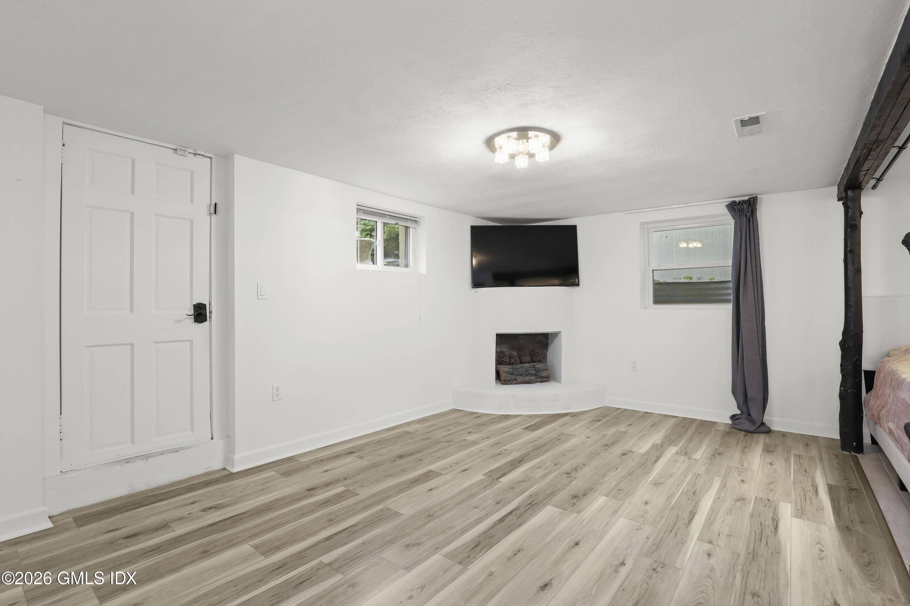11 Rex Street Greenwich, CT 06831 - Photo 12 of 22 a view of a livingroom with wooden floor and a flat screen tv