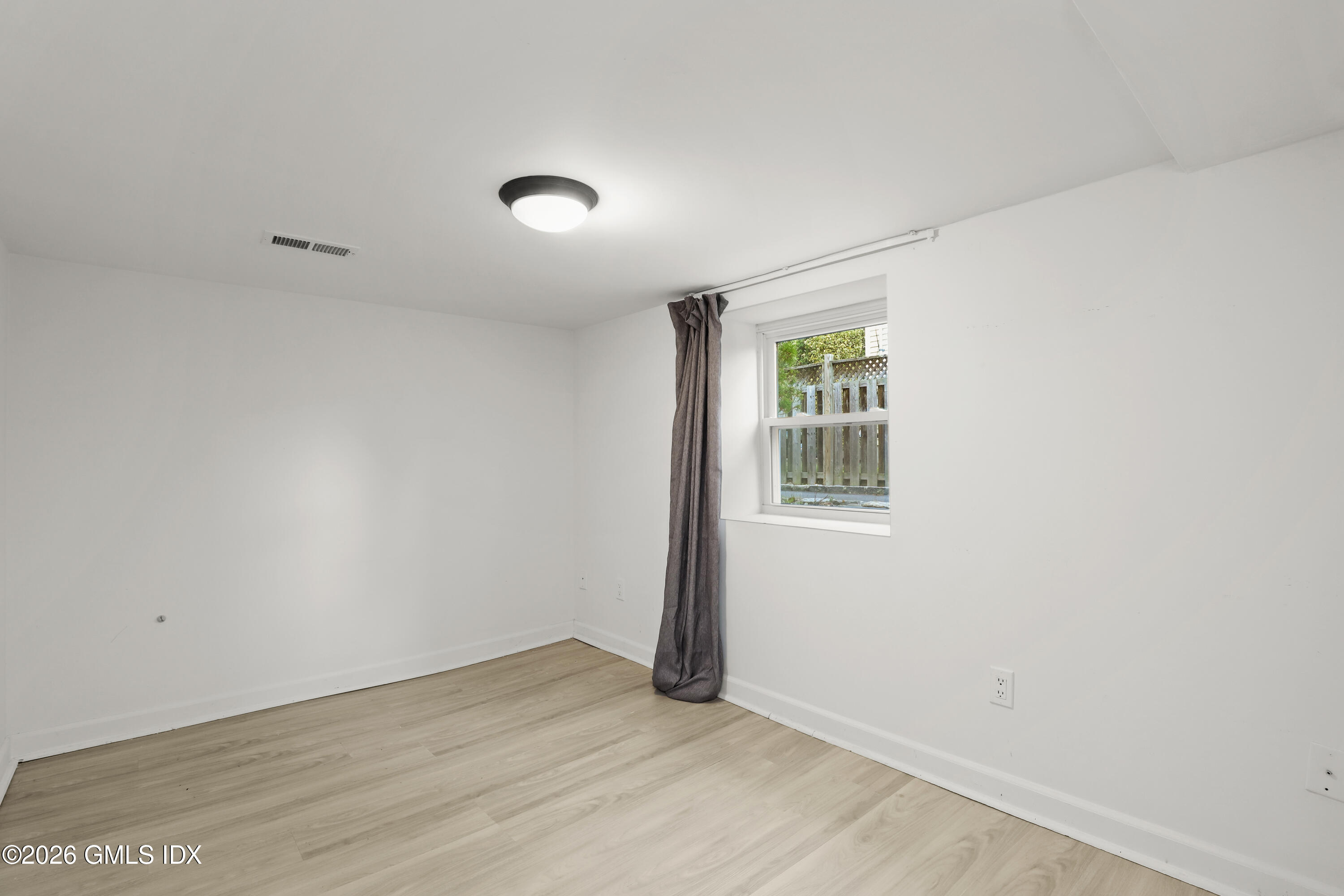 11 Rex Street Greenwich, CT 06831 - Photo 13 of 22 an empty room with wooden floor and windows