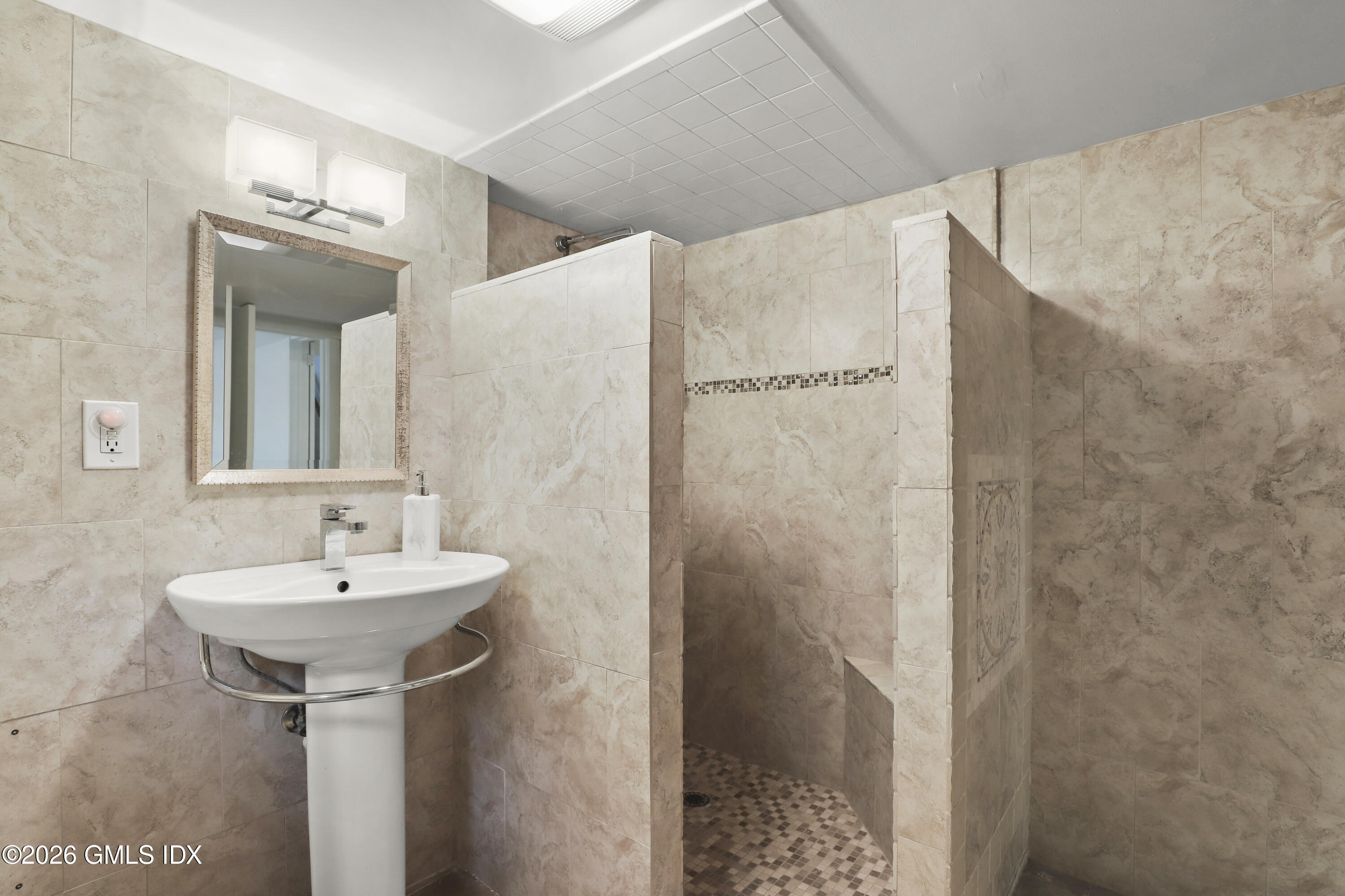 11 Rex Street Greenwich, CT 06831 - Photo 14 of 22 a bathroom with a sink a mirror and shower