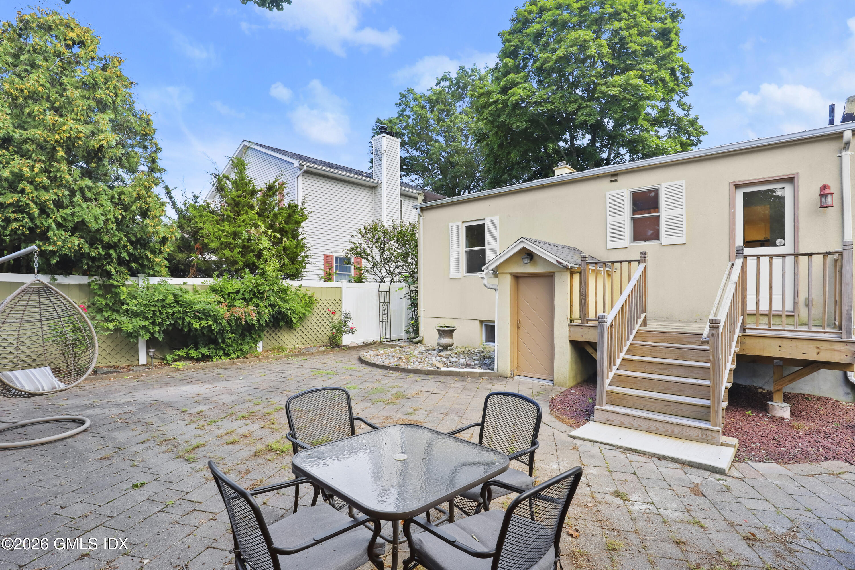11 Rex Street Greenwich, CT 06831 - Photo 15 of 22 a view of a patio with table and chairs with wooden floor and plants
