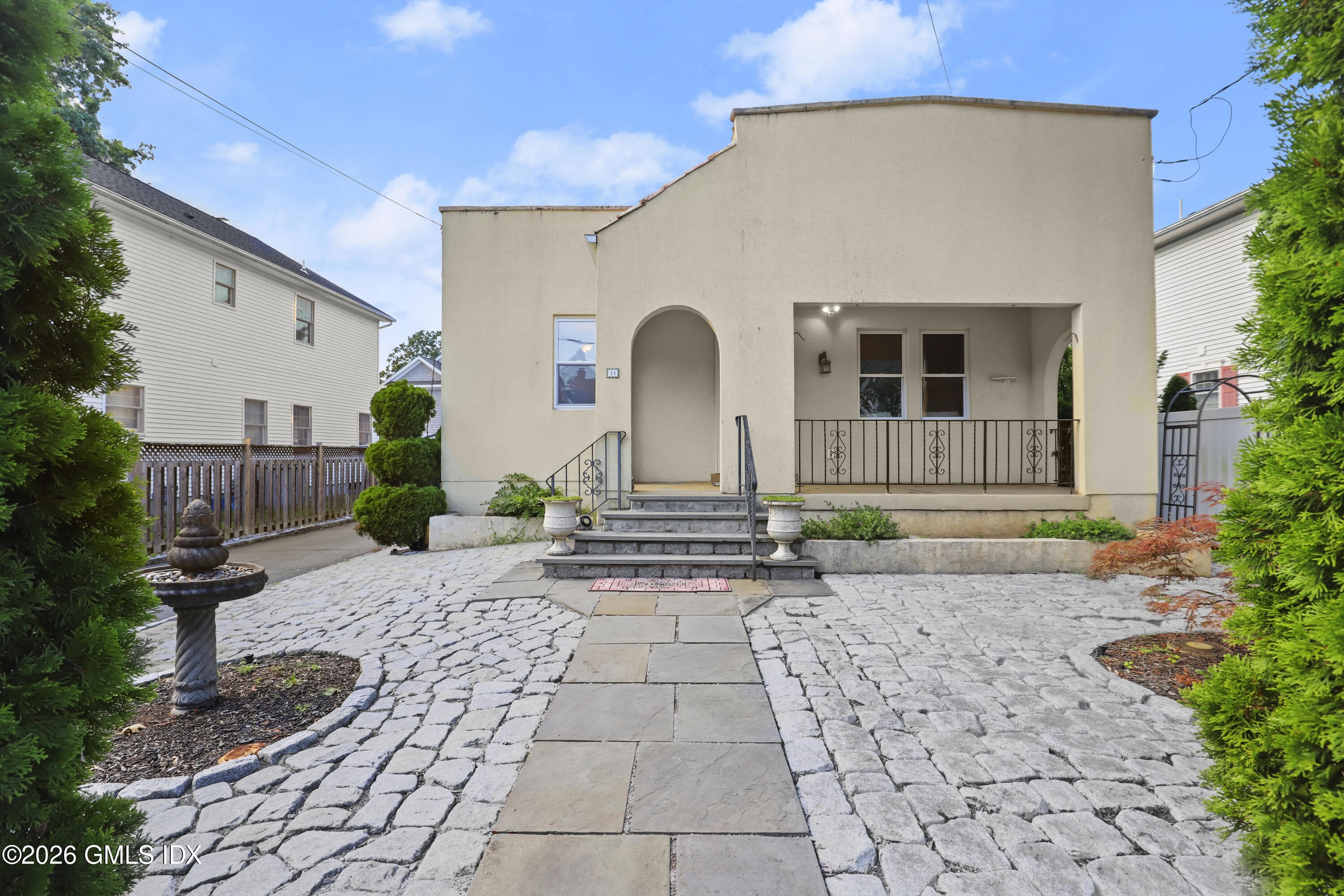 11 Rex Street Greenwich, CT 06831 - Photo 16 of 22 a front view of a house with garden