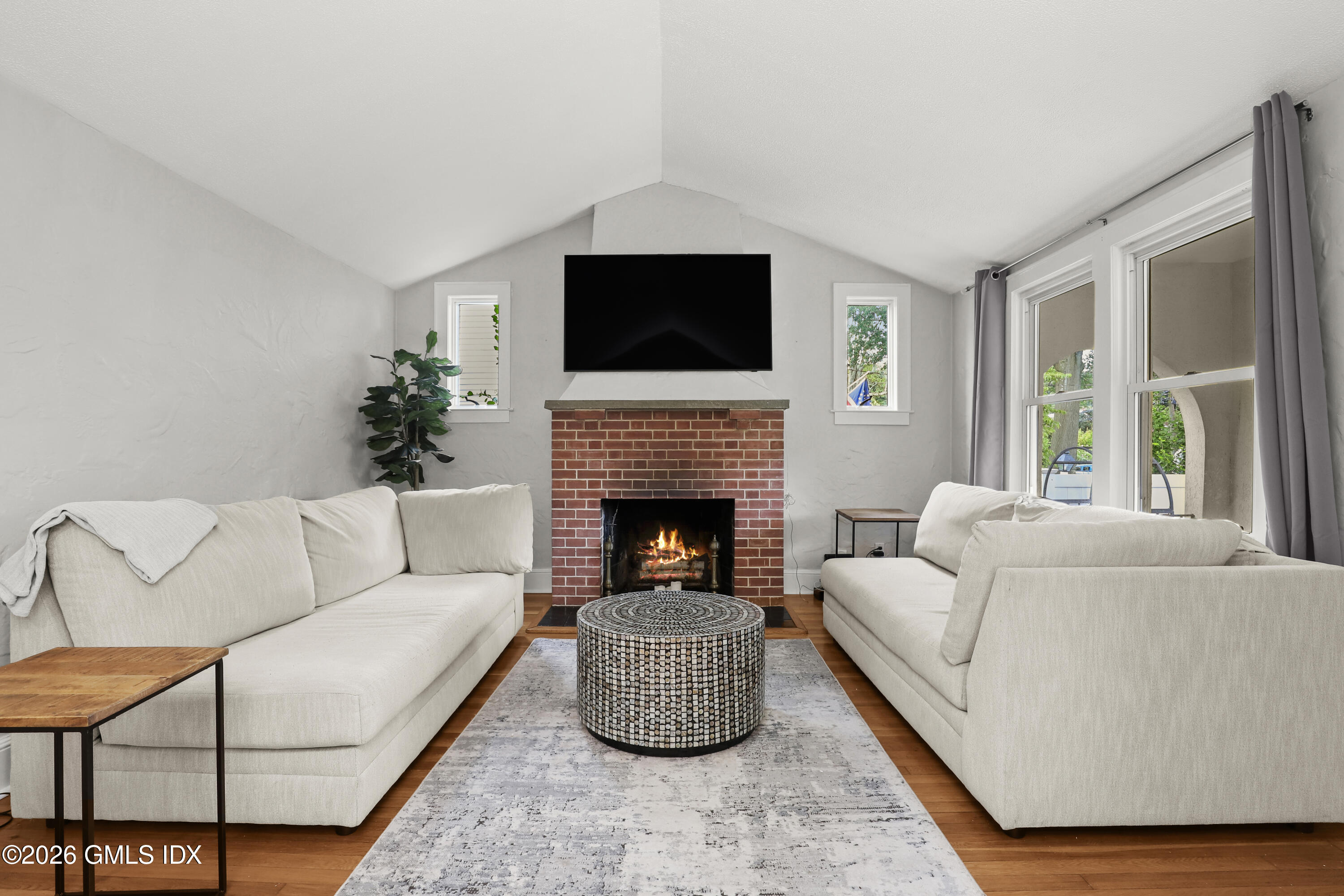 11 Rex Street Greenwich, CT 06831 - Photo 2 of 22 a living room with furniture a flat screen tv and a fireplace