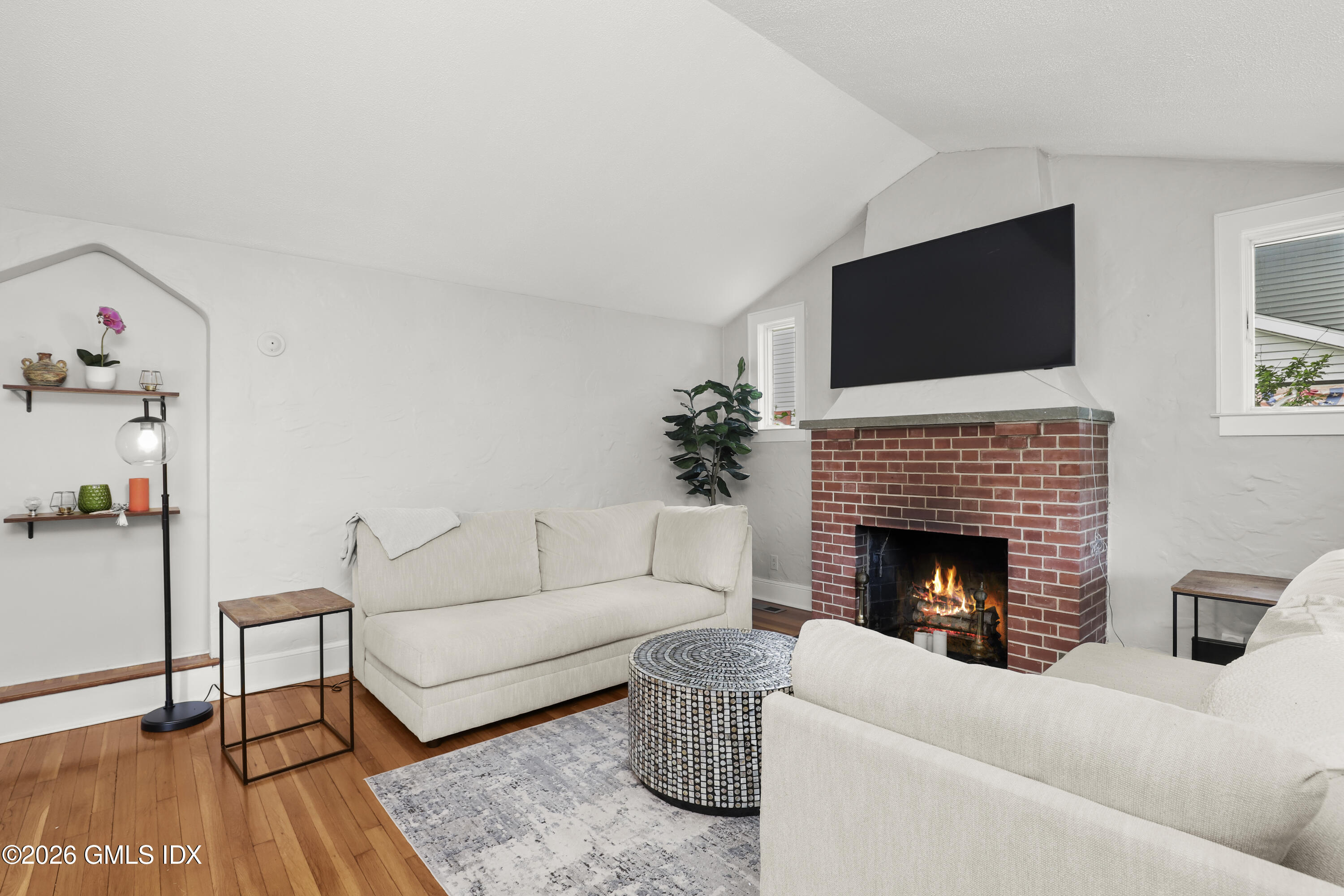 11 Rex Street Greenwich, CT 06831 - Photo 3 of 22 a living room with furniture a flat screen tv and a fireplace