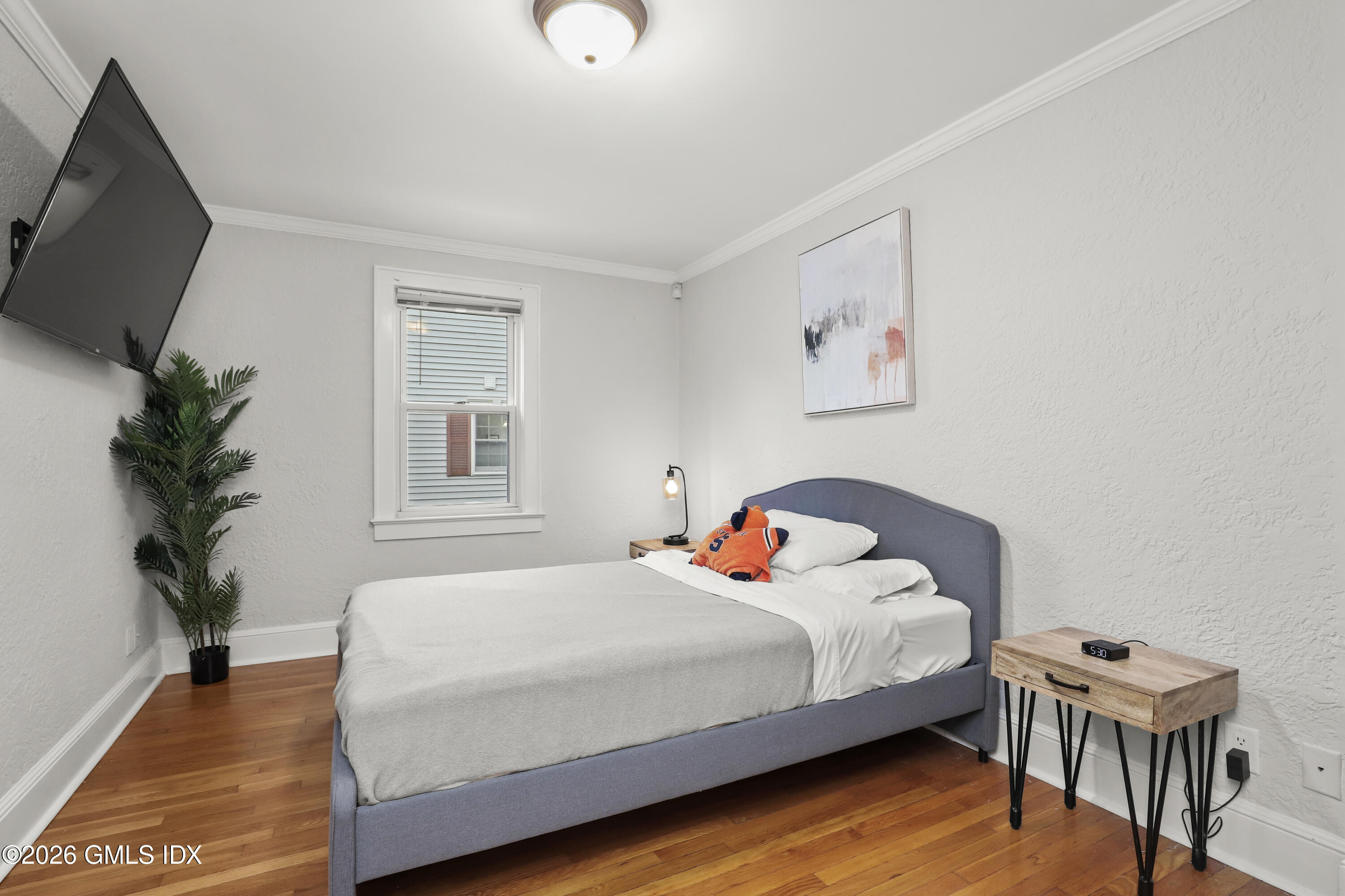 11 Rex Street Greenwich, CT 06831 - Photo 9 of 22 a bedroom with a bed and a potted plant