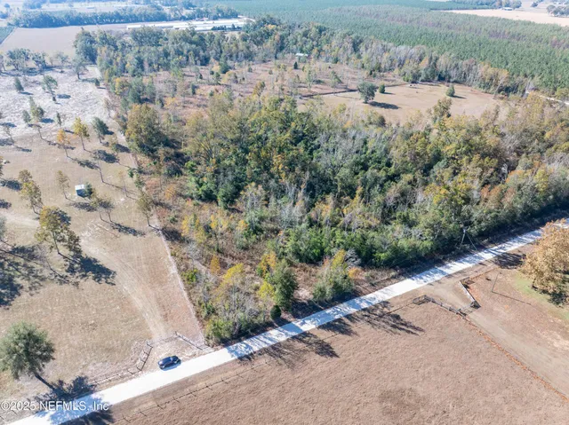 a view of a yard with wooden fence