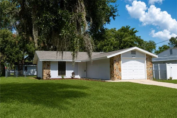 a front view of house with yard and green space