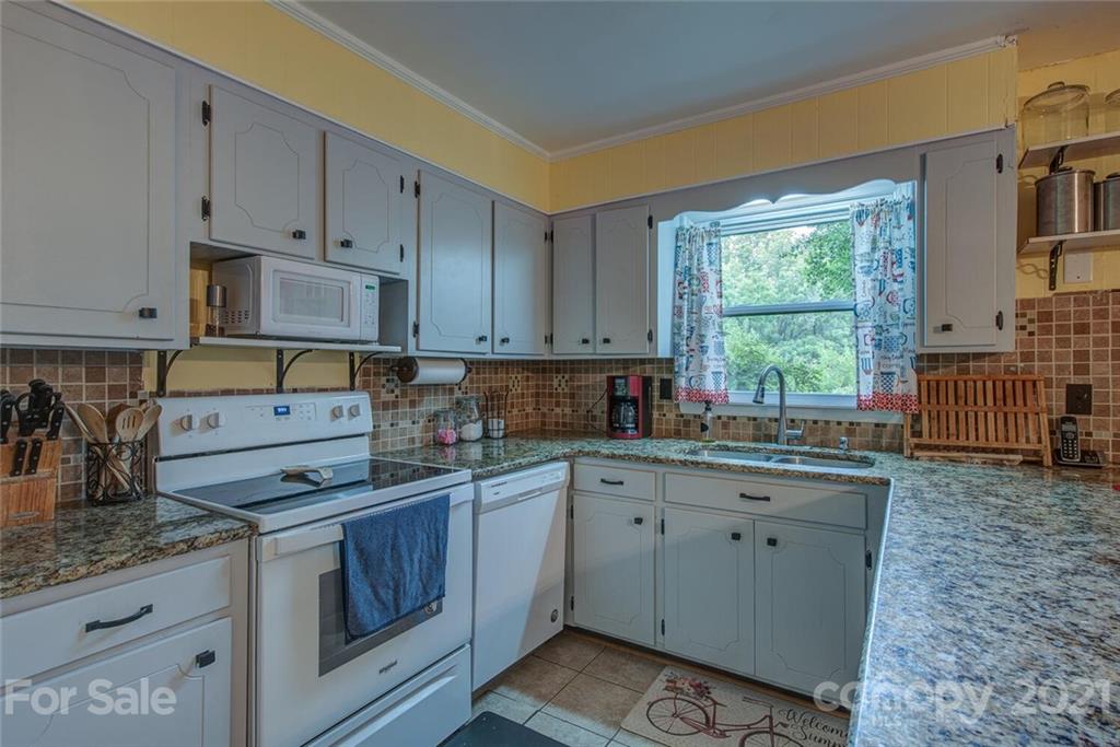 647 Blacksnake Road Stanley, NC 28164 - Photo 11 of 35 a kitchen with cabinets appliances a sink and a window