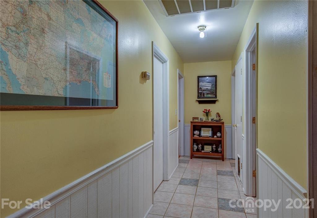 647 Blacksnake Road Stanley, NC 28164 - Photo 16 of 35 a view of a hallway with wooden shelves