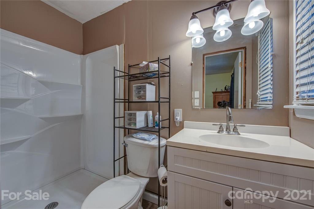 647 Blacksnake Road Stanley, NC 28164 - Photo 18 of 35 a bathroom with a toilet sink and mirror
