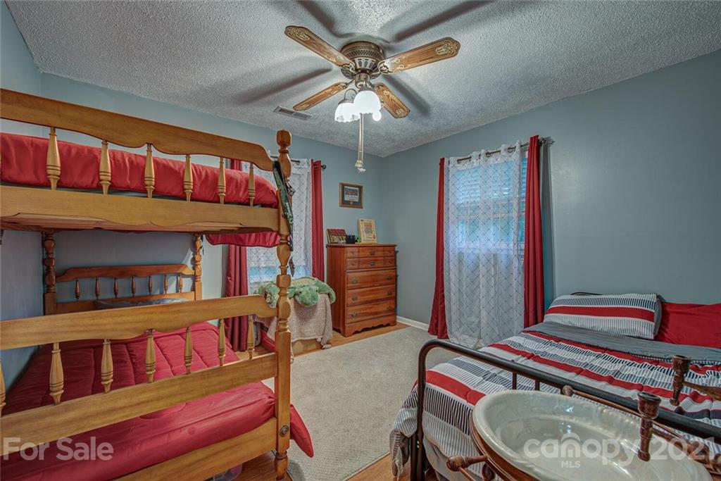 647 Blacksnake Road Stanley, NC 28164 - Photo 19 of 35 a room with furniture and a bookshelf