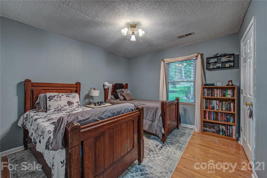 647 Blacksnake Road Stanley, NC 28164 - Photo 20 of 35 a bed room with a bed and a book shelf