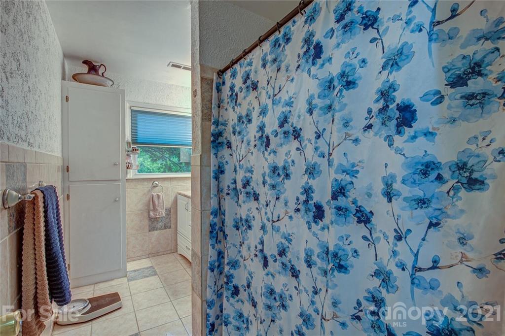 647 Blacksnake Road Stanley, NC 28164 - Photo 21 of 35 a bathroom with a shower and a sink
