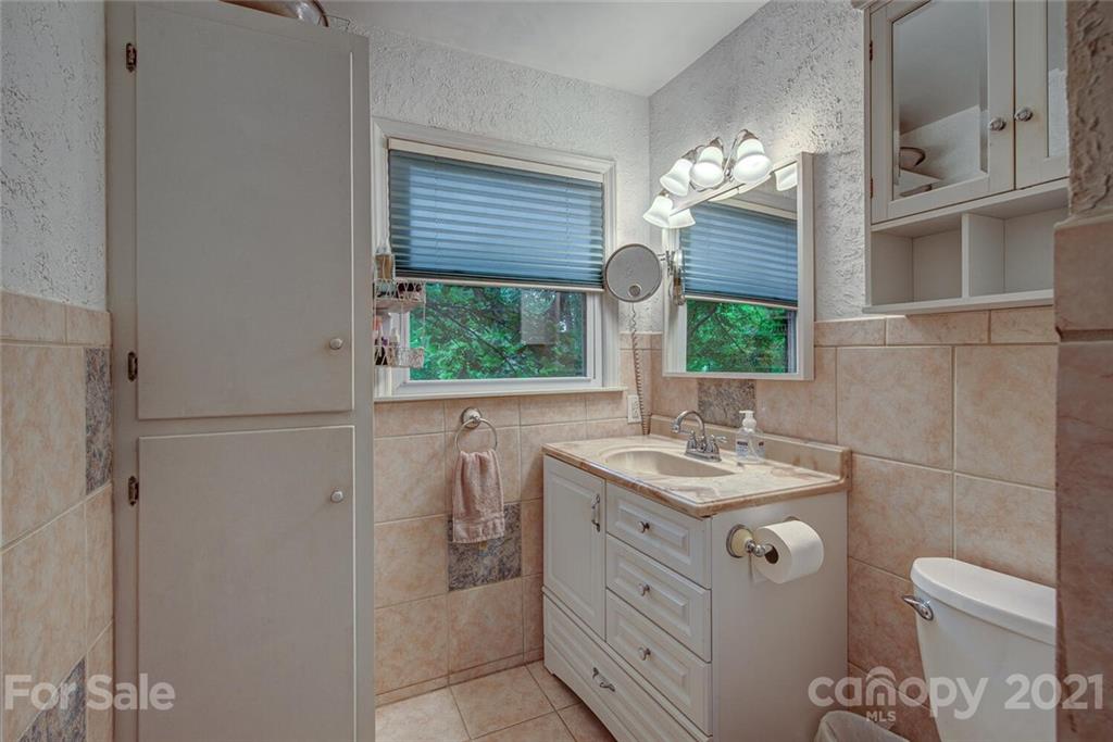 647 Blacksnake Road Stanley, NC 28164 - Photo 22 of 35 a bathroom with a granite countertop sink a toilet and a mirror