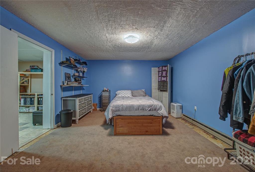 647 Blacksnake Road Stanley, NC 28164 - Photo 25 of 35 a spacious bedroom with a bed and a walk in closet