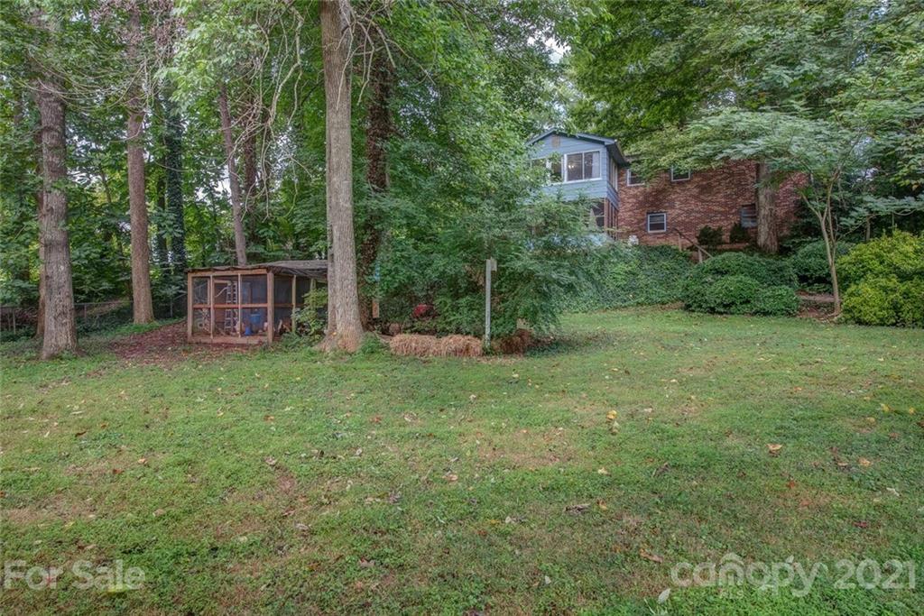 647 Blacksnake Road Stanley, NC 28164 - Photo 31 of 35 a backyard of a house with plants and large trees