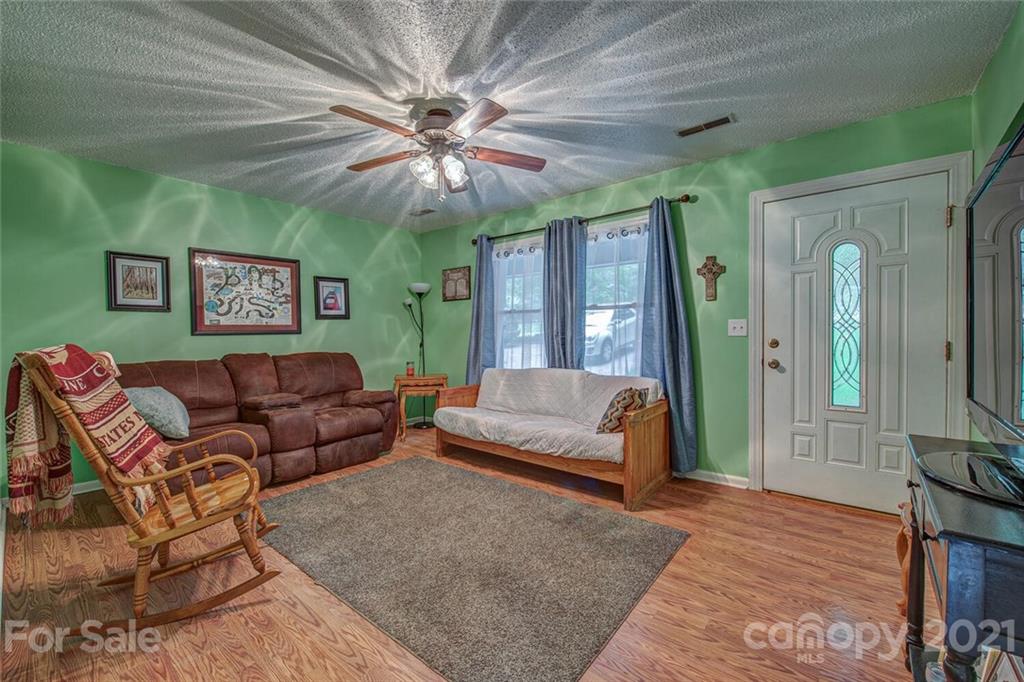 647 Blacksnake Road Stanley, NC 28164 - Photo 5 of 35 a living room with furniture and a large window