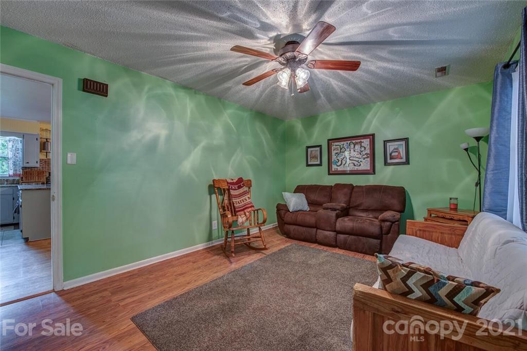 647 Blacksnake Road Stanley, NC 28164 - Photo 6 of 35 a living room with furniture and a wooden floor