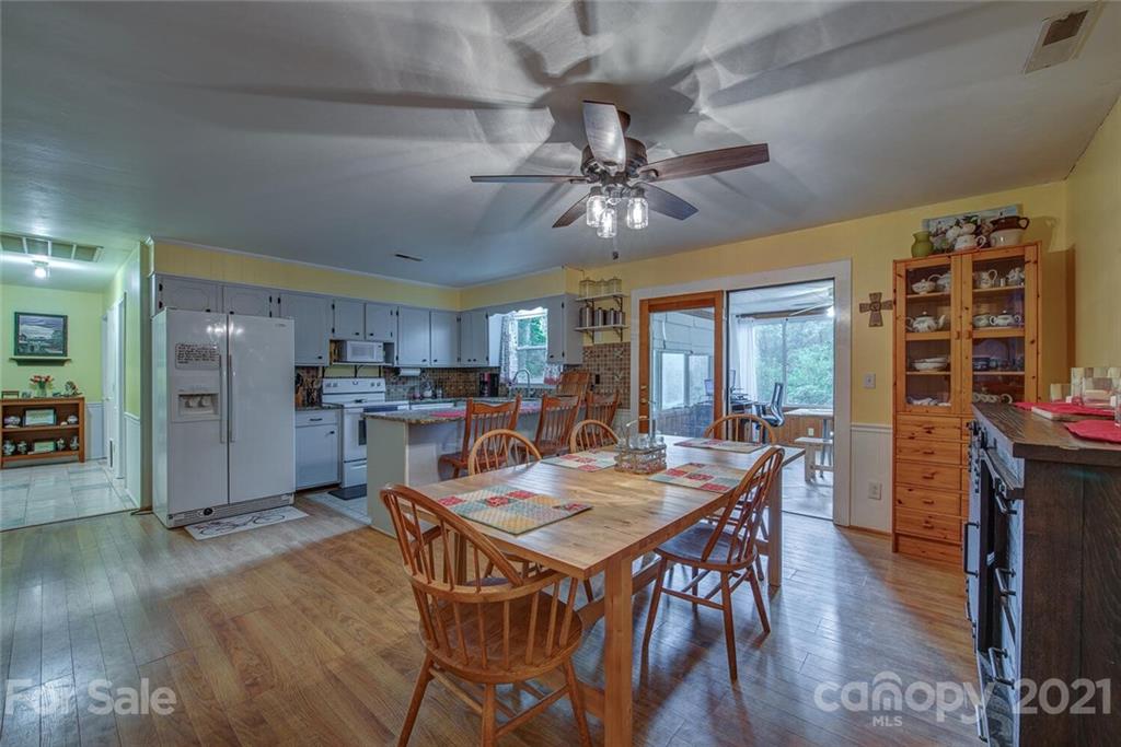 647 Blacksnake Road Stanley, NC 28164 - Photo 7 of 35 a view of a dining room with furniture window and wooden floor