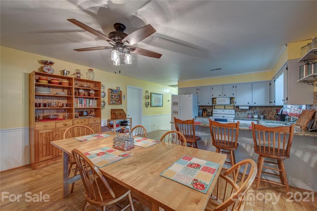 647 Blacksnake Road Stanley, NC 28164 - Photo 8 of 35 a view of a dining room with furniture window and wooden floor