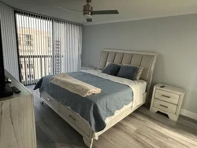 a bedroom with a bed and a window