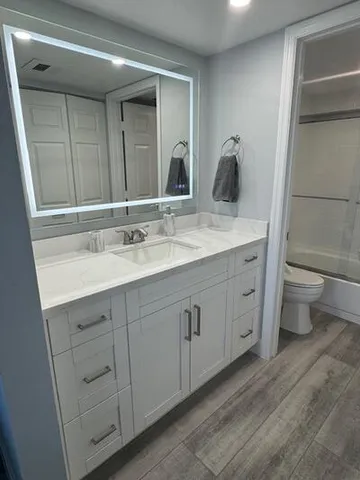 a bathroom with a double vanity sink and a mirror