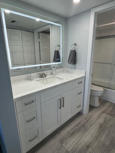 9500 South Ocean Drive, Unit 1909 Jensen Beach, FL 34957 - Photo 14 of 40 a bathroom with a double vanity sink and a mirror