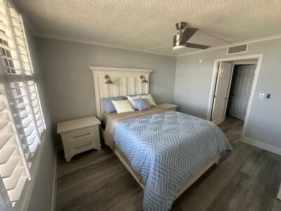 9500 South Ocean Drive, Unit 1909 Jensen Beach, FL 34957 - Photo 16 of 40 a bedroom with a bed and wooden floor