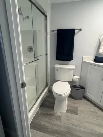 a bathroom with a toilet and a shower