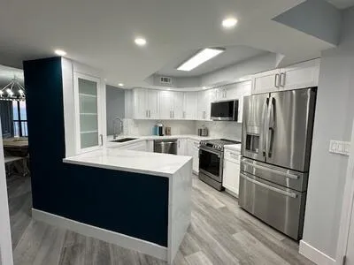 a kitchen with refrigerator cabinets and wooden floor