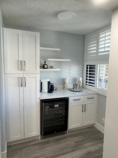 9500 South Ocean Drive, Unit 1909 Jensen Beach, FL 34957 - Photo 3 of 40 a kitchen with white cabinets and sink