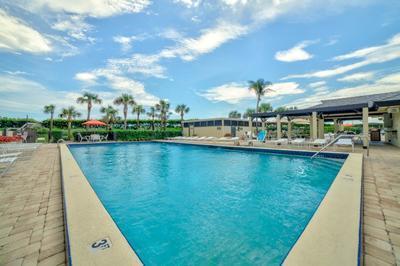 9500 South Ocean Drive, Unit 1909 Jensen Beach, FL 34957 - Photo 32 of 40 a view of swimming pool with outdoor seating and plants