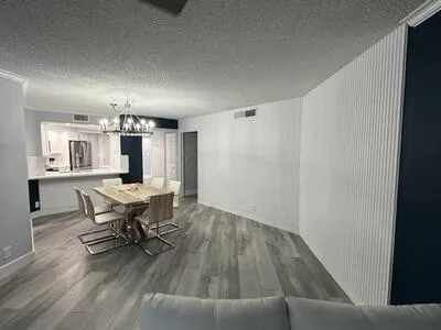 a view of a dining room with furniture and window
