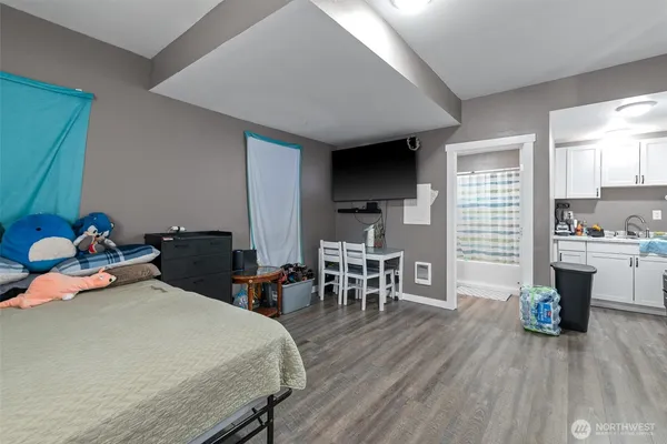 a bedroom with furniture and a wooden floor