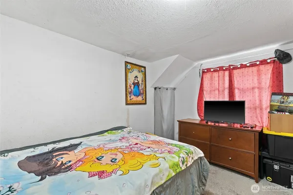 a bedroom with a bed and a flat screen tv