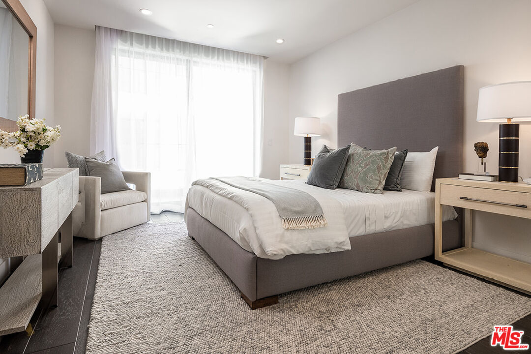 411 South Hamel Road, Unit 405 Los Angeles, CA 90048 - Photo 11 of 15 a bedroom with a bed table flowerpot and a window