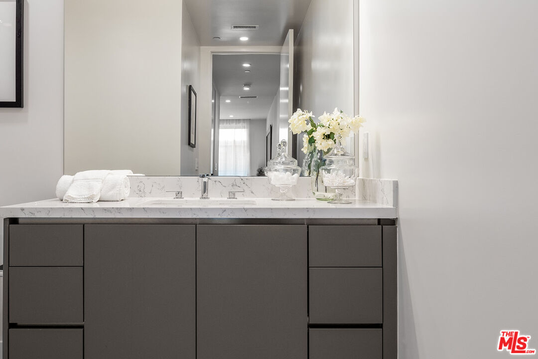 411 South Hamel Road, Unit 405 Los Angeles, CA 90048 - Photo 13 of 15 a bathroom with a sink and a mirror