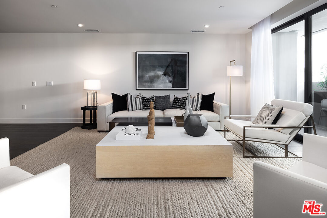 411 South Hamel Road, Unit 405 Los Angeles, CA 90048 - Photo 2 of 15 a living room with furniture and a large window