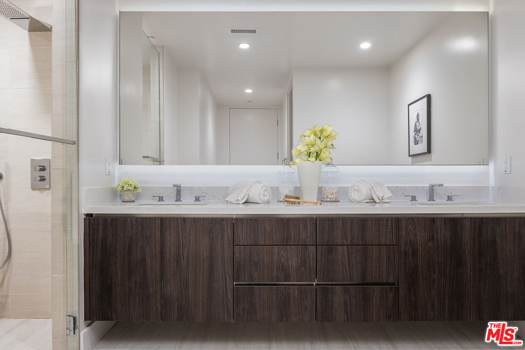 411 South Hamel Road, Unit 405 Los Angeles, CA 90048 - Photo 9 of 15 a bathroom with double sink and a mirror