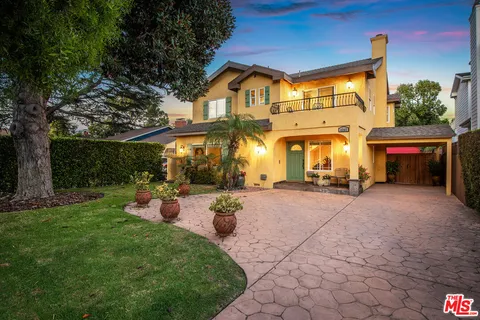 a view of a house with backyard porch and sitting area