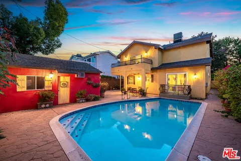 a view of a swimming pool with an outdoor seating
