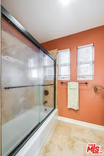 a kitchen with stainless steel appliances a stove a sink and a refrigerator